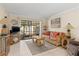 Living room with comfortable seating, and access to a screened patio at 6703 Midnight Pass Rd # 117, Sarasota, FL 34242