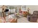 Living room with wicker furniture, a TV and access to a screened patio at 6703 Midnight Pass Rd # 117, Sarasota, FL 34242