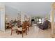 Open living and dining area with tile floors and access to screened patio at 6703 Midnight Pass Rd # 117, Sarasota, FL 34242