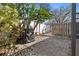 Private patio area with brick pavers and lush landscaping at 6703 Midnight Pass Rd # 117, Sarasota, FL 34242