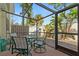 Screened patio with a table and chairs, overlooking the backyard at 6703 Midnight Pass Rd # 117, Sarasota, FL 34242