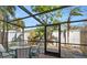 Relaxing screened patio with table and chairs, perfect for outdoor dining at 6703 Midnight Pass Rd # 117, Sarasota, FL 34242