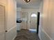 Bright entryway with herringbone tile floor and kitchen access at 703 32Nd Street E Ct, Bradenton, FL 34208