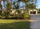 Landscaped front yard with tropical plants and driveway at 703 32Nd Street E Ct, Bradenton, FL 34208