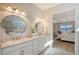 Bathroom with double vanity, large mirrors, and a view into the bedroom at 7125 Gradford Ct, Lakewood Ranch, FL 34202