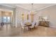 Spacious dining room with a stone accent wall and a large chandelier at 7125 Gradford Ct, Lakewood Ranch, FL 34202