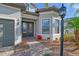 Elegant entryway with double doors, a decorative lantern, and a manicured landscape at 7125 Gradford Ct, Lakewood Ranch, FL 34202