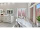 Luxurious bathroom with a freestanding tub and marble-tiled flooring at 7800 18Th W Ave, Bradenton, FL 34209