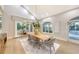 Elegant dining room with hardwood floors, large windows, and a stylish wooden table at 7800 18Th W Ave, Bradenton, FL 34209