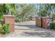 Ornate entry gate with lion statues and brick pillars at 7800 18Th W Ave, Bradenton, FL 34209