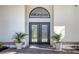 Double front doors with glass accents and planters at 7800 18Th W Ave, Bradenton, FL 34209