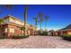 Elegant two-story brick home featuring a spacious brick driveway, lush landscaping, and mature palm trees at 7800 18Th W Ave, Bradenton, FL 34209