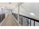 Bright hallway with hardwood flooring and a metal railing at 7800 18Th W Ave, Bradenton, FL 34209