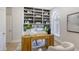 Home office with built-in shelving and an arched window at 7800 18Th W Ave, Bradenton, FL 34209