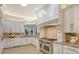 Updated kitchen with white cabinets, granite counters, and high-end appliances at 7800 18Th W Ave, Bradenton, FL 34209