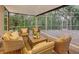 Spacious screened patio with wicker furniture and a view of lush landscaping at 7800 18Th W Ave, Bradenton, FL 34209