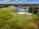 Aerial view of golf course with pond and homes visible at 8532 Eagle Preserve Way, Sarasota, FL 34241