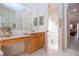 Main bathroom with double sinks and access to toilet and hallway at 8532 Eagle Preserve Way, Sarasota, FL 34241