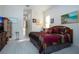 Main bedroom with light flooring, a comfy bed, and a large TV at 8532 Eagle Preserve Way, Sarasota, FL 34241