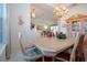 Formal dining room with a large table, chandelier, and access to kitchen at 8532 Eagle Preserve Way, Sarasota, FL 34241