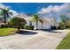Three car garage and a long driveway leading up to the house at 8532 Eagle Preserve Way, Sarasota, FL 34241