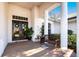 Spacious front porch with a tiled floor, wooden bench, and lush greenery at 8532 Eagle Preserve Way, Sarasota, FL 34241