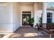 Welcoming front porch with tiled floor, wooden bench, and potted plants at 8532 Eagle Preserve Way, Sarasota, FL 34241