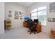 Bright home office features a large window and comfortable seating at 8532 Eagle Preserve Way, Sarasota, FL 34241