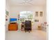 Home office with built-in desk and large window overlooking the backyard at 8532 Eagle Preserve Way, Sarasota, FL 34241