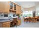 Kitchen features light wood cabinets and built-in desk area at 8532 Eagle Preserve Way, Sarasota, FL 34241