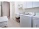 Bright laundry room with built-in cabinets and a utility sink at 8532 Eagle Preserve Way, Sarasota, FL 34241