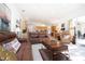 Spacious living room with leather couches and kitchen access at 8532 Eagle Preserve Way, Sarasota, FL 34241