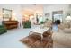 Open living room with comfortable seating, a piano, and views to other rooms at 8532 Eagle Preserve Way, Sarasota, FL 34241