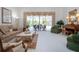 Bright living room with view to pool area and comfortable seating at 8532 Eagle Preserve Way, Sarasota, FL 34241