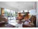 Living area with leather couches, large TV, and pool access at 8532 Eagle Preserve Way, Sarasota, FL 34241