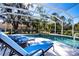 Enjoy this refreshing pool with blue lounge chairs at 8532 Eagle Preserve Way, Sarasota, FL 34241