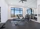 Modern home gym with lake view and various equipment at 991 Seascape Pl, Sarasota, FL 34240