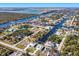 Aerial view of canal-front property with surrounding houses at 10489 St Paul Dr, Port Charlotte, FL 33981