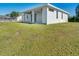 Back of house with covered patio and grassy backyard at 10489 St Paul Dr, Port Charlotte, FL 33981