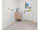 Modern laundry room with a built-in sink and cabinetry at 1108 Spencer Ave, Clearwater, FL 33756