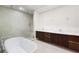 Elegant bathroom with a freestanding tub, dual sinks, and a glass-enclosed shower at 111 Golden Gate Pt # 403, Sarasota, FL 34236