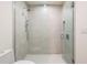 Bright bathroom with a glass-enclosed shower and modern fixtures at 111 Golden Gate Pt # 403, Sarasota, FL 34236