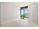 Bright bedroom with tile flooring, large windows, and a scenic water view at 111 Golden Gate Pt # 403, Sarasota, FL 34236