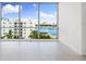Bedroom with a large window showcasing views of the marina and waterfront at 111 Golden Gate Pt # 403, Sarasota, FL 34236
