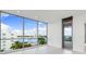 Bright bedroom featuring a balcony and panoramic views of the city and waterfront at 111 Golden Gate Pt # 403, Sarasota, FL 34236