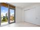 Cozy bedroom with a balcony and sliding closet door at 111 Golden Gate Pt # 403, Sarasota, FL 34236