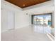 Bright, minimalist bedroom with floor-to-ceiling windows and waterfront views at 111 Golden Gate Pt # 403, Sarasota, FL 34236
