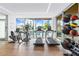 Bright gym with modern equipment and a view of the pool at 111 Golden Gate Pt # 403, Sarasota, FL 34236