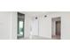 Hallway with natural light with views to the balcony, bathroom and bedroom at 111 Golden Gate Pt # 403, Sarasota, FL 34236