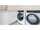 Laundry room with modern washer and dryer at 111 Golden Gate Pt # 403, Sarasota, FL 34236